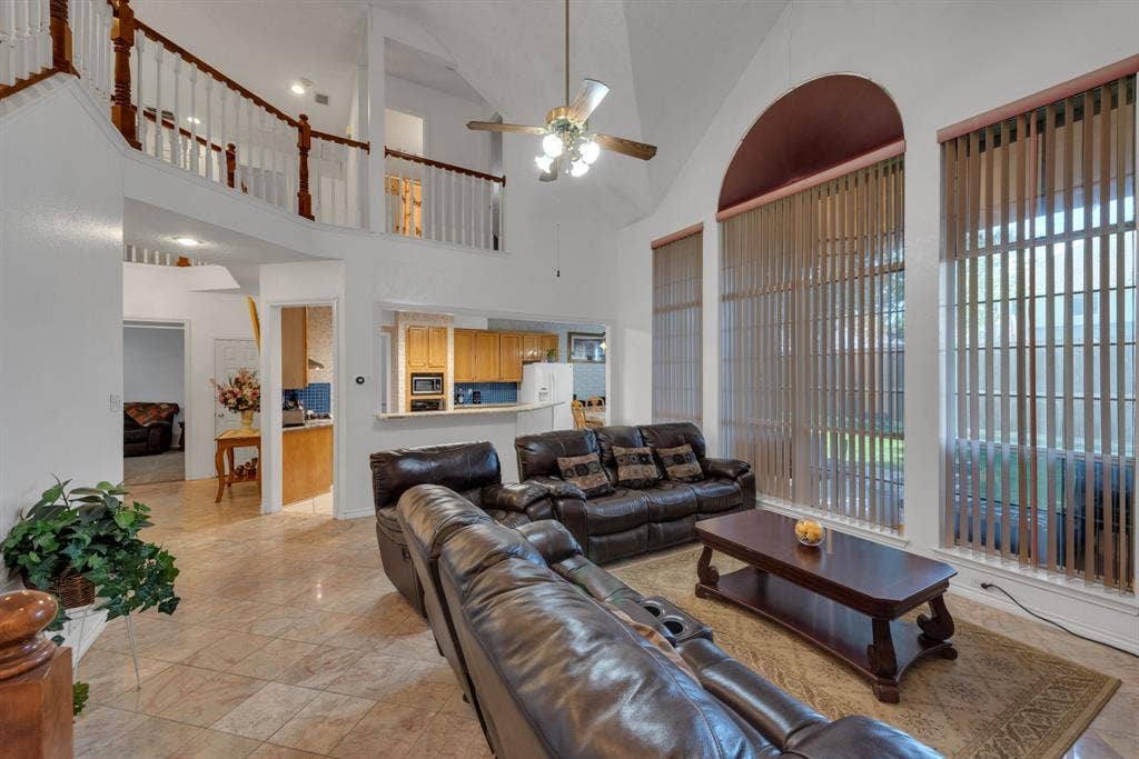 4622 Devonshire Drive, Grand Prairie, TX 75052 Two-story living area featuring vaulted ceilings, a ceiling fan with light fixture, and tile flooring