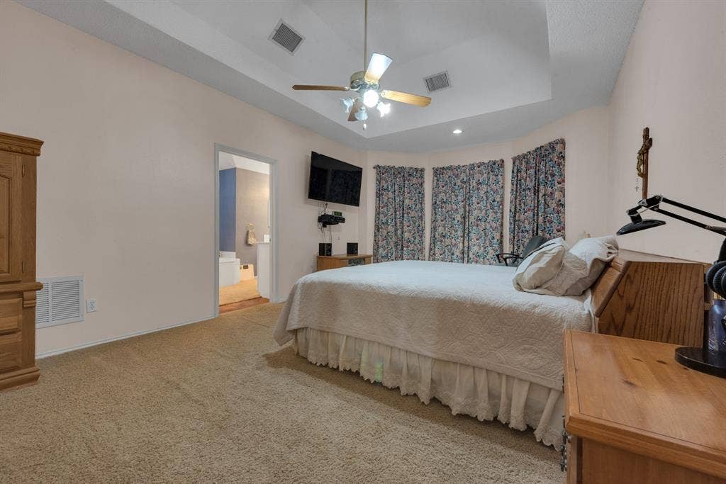 4622 Devonshire Drive, Grand Prairie, TX 75052 Bedroom with tray ceiling, recessed lighting, and a ceiling fan