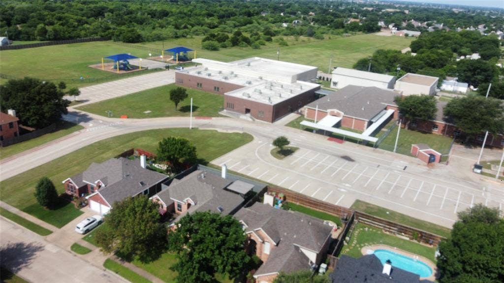 4622 Devonshire Drive, Grand Prairie, TX 75052 Aerial perspective showcasing a residential community bordering a large educational facility