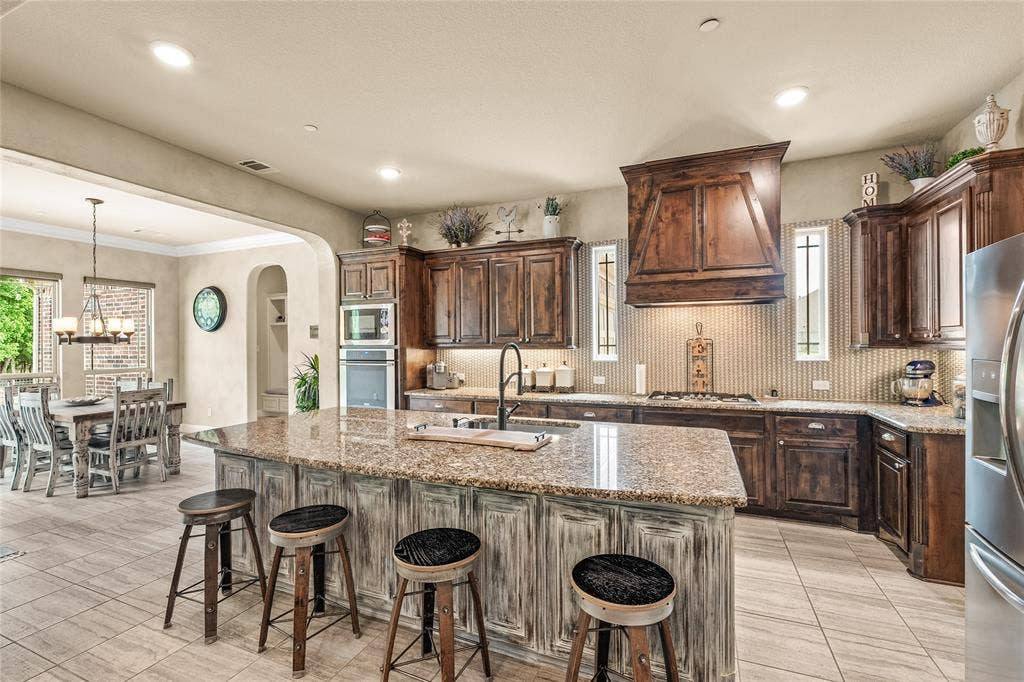 1615 Sara Cove, Lucas, TX 75002 beautiful wood cabinetry with gas cooktop and 2 ovens