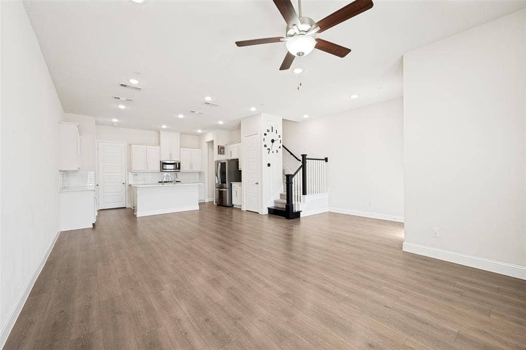 12986 Jk Ojha Street, Farmers Branch, TX 75234 Open-concept living space featuring wood-finish flooring, recessed lighting, and a ceiling fan