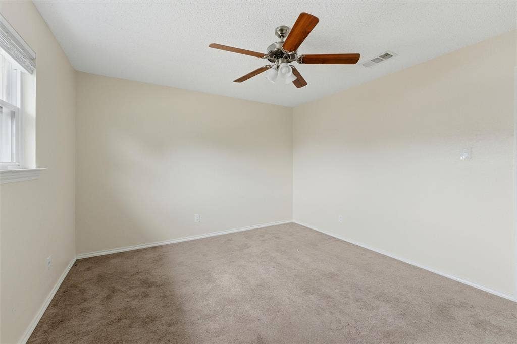 401 N 7th Street, Midlothian, TX 76065 Neutral-toned room with plush carpet flooring, white baseboards, and a window with blinds