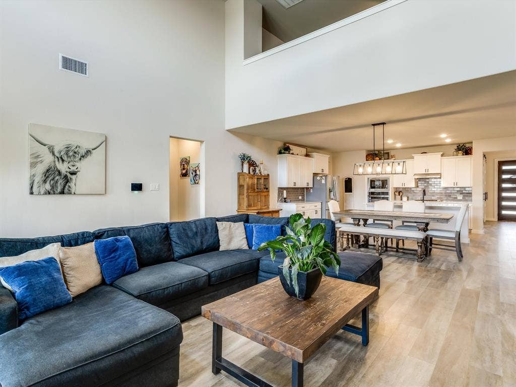 1021 Daylily Drive, Northlake, TX 76226 Expansive living area featuring soaring ceilings and wood-finish flooring