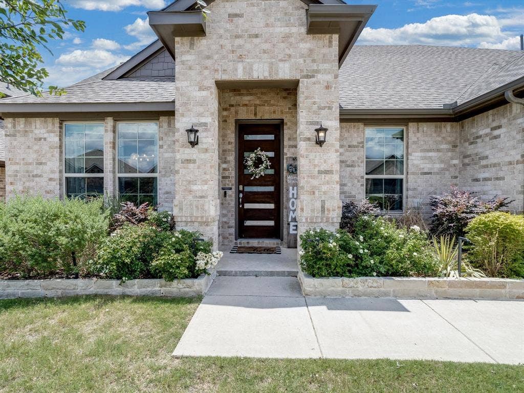 1021 Daylily Drive, Northlake, TX 76226 Traditional-style residence featuring a prominent brick facade and a multi-gabled roofline