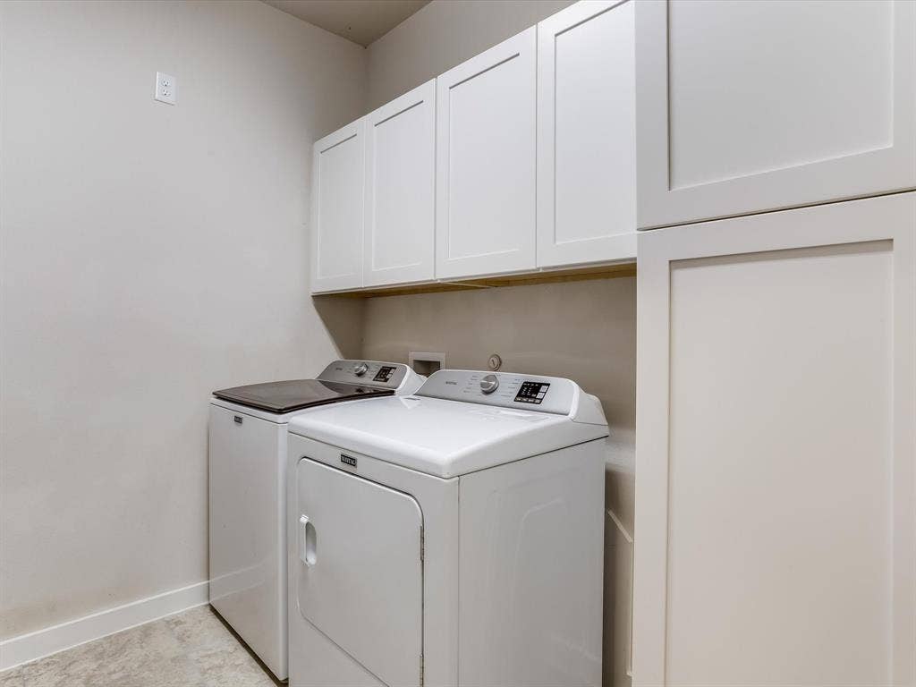1021 Daylily Drive, Northlake, TX 76226 Laundry area featuring overhead white shaker cabinetry, an integrated tall storage cabinet, light-toned walls, and a durable tile floor