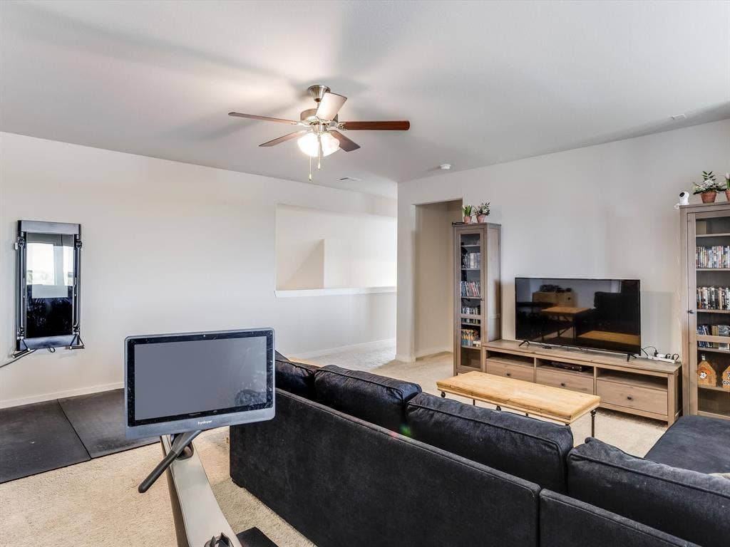 1021 Daylily Drive, Northlake, TX 76226 Spacious living area featuring light-toned walls, a ceiling fan with integrated lighting, and carpeted flooring
