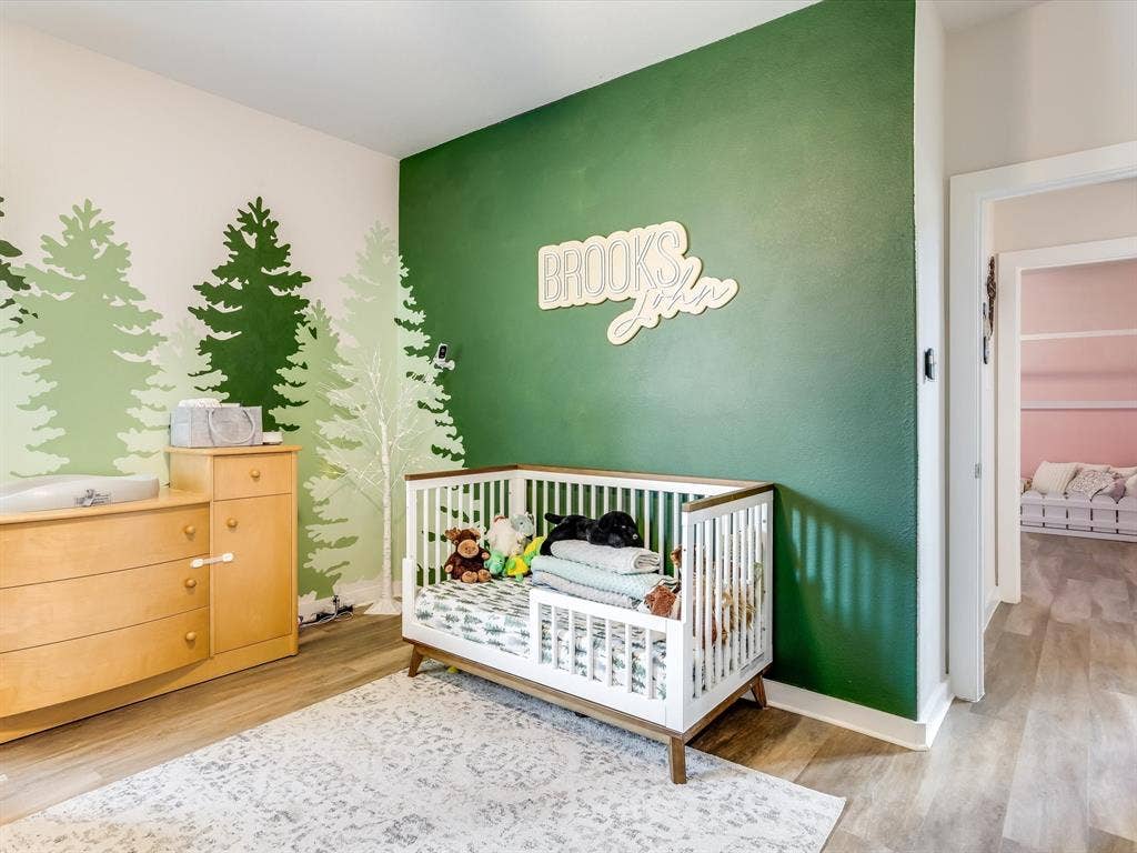 1021 Daylily Drive, Northlake, TX 76226 Spacious room featuring wood-finish flooring and a distinctive two-toned wall design with forest-themed graphics