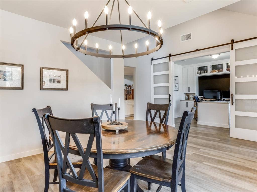 1021 Daylily Drive, Northlake, TX 76226 Dining area featuring a contemporary circular chandelier and wood-finish flooring