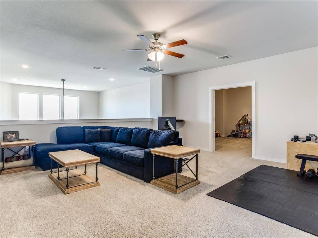 1021 Daylily Drive, Northlake, TX 76226 Versatile upper-level space featuring light-colored carpeting, a ceiling fan with integrated lighting, and recessed ceiling lights