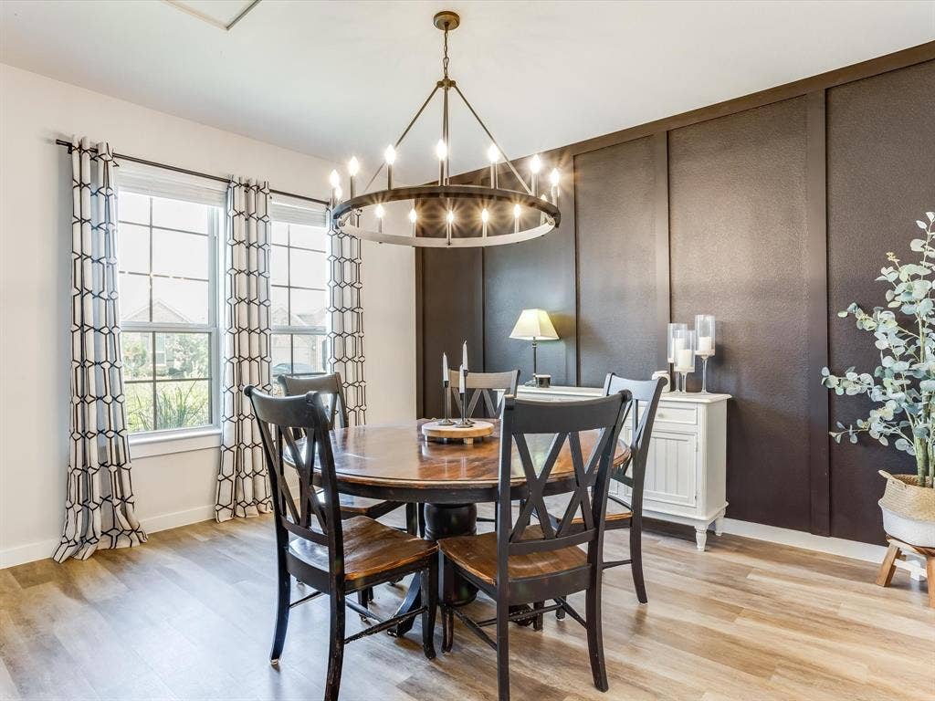 1021 Daylily Drive, Northlake, TX 76226 Formal dining space featuring wood-finish flooring, a contemporary chandelier, two large windows, a paneled accent wall, and recessed lighting