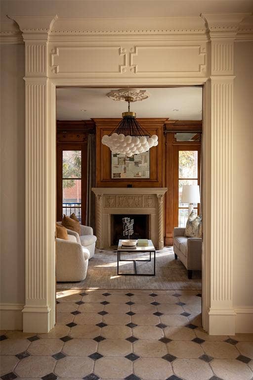 Arched doorway with decorative molding and fluted columns