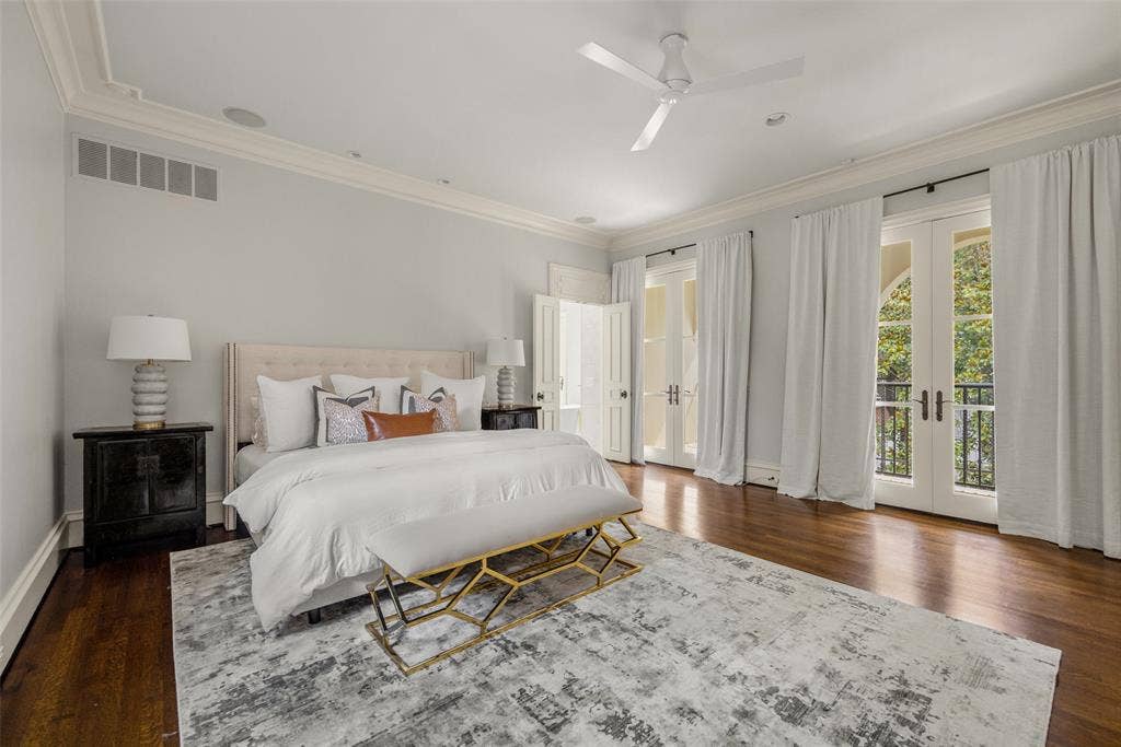 Hardwood flooring complemented by crown molding and a ceiling fan