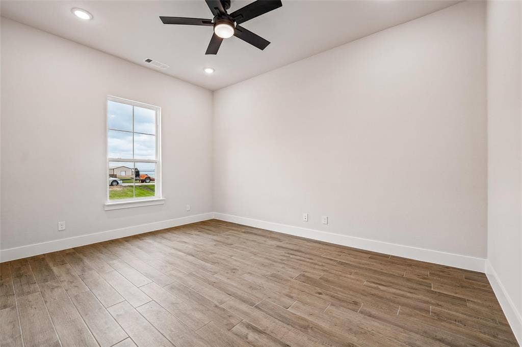 12413 Hornfels Drive, Krum, TX 76249 Wood-finish plank flooring, recessed lighting, and a ceiling fan with integrated lighting