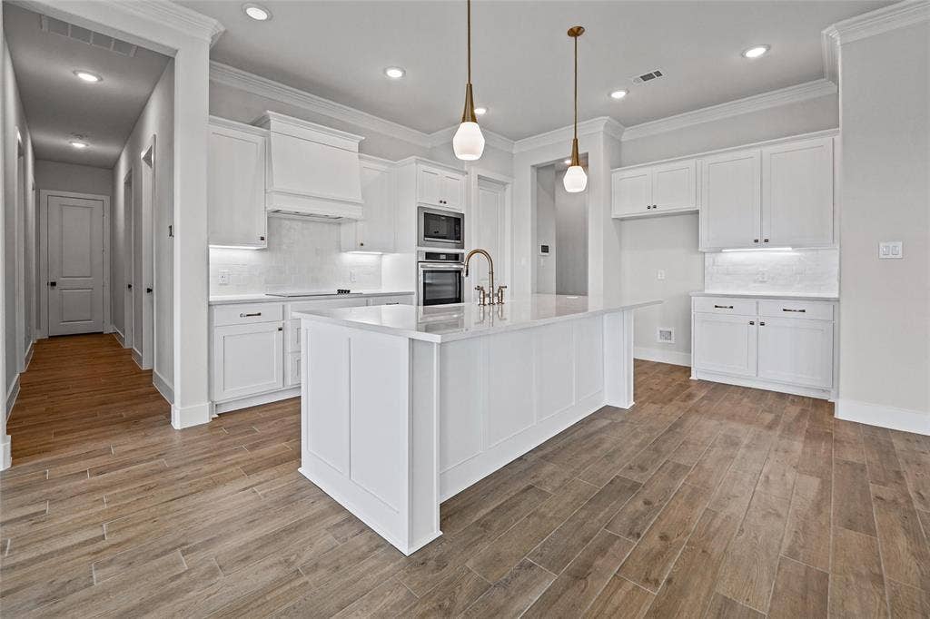 12413 Hornfels Drive, Krum, TX 76249 Expansive kitchen island with a white countertop and seating