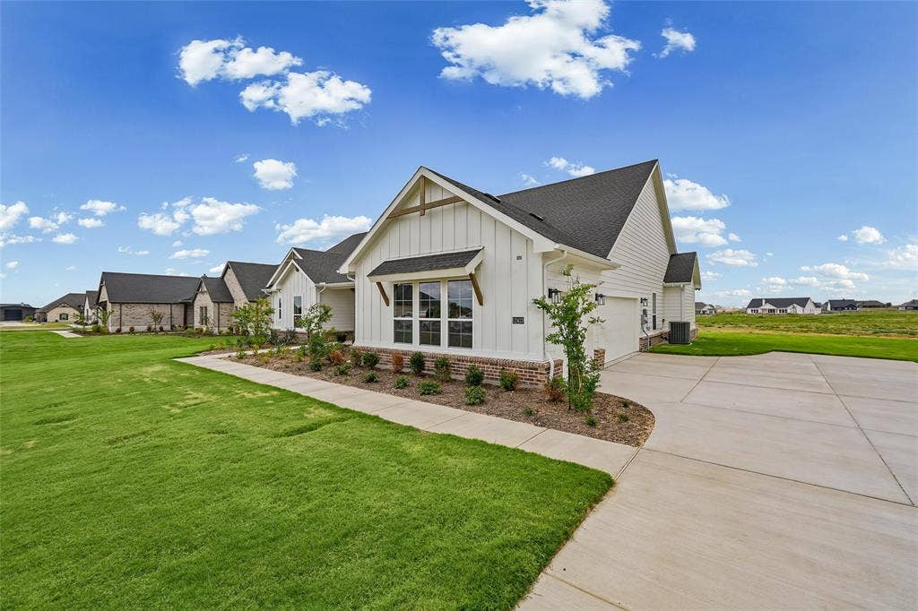 12413 Hornfels Drive, Krum, TX 76249 White board and batten siding with brick accents