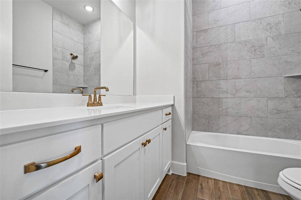 12413 Hornfels Drive, Krum, TX 76249 White vanity with gold-tone hardware, white countertop, and wood-finish flooring