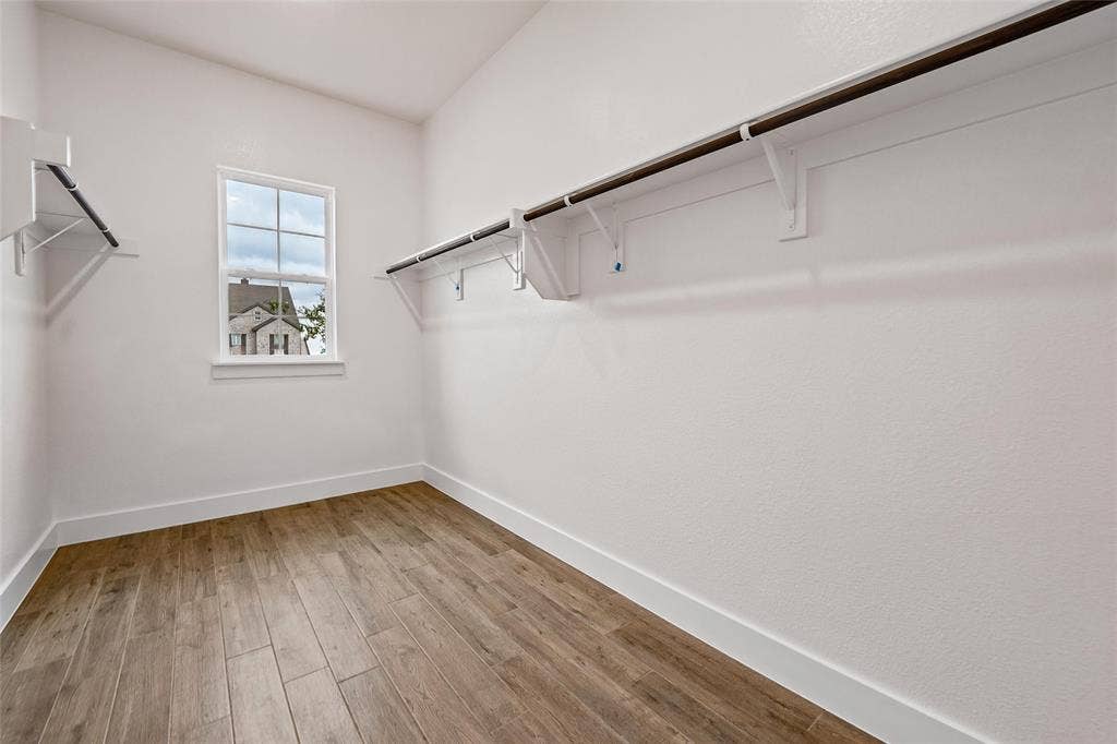 12413 Hornfels Drive, Krum, TX 76249 Wood-finish flooring, white walls, built-in shelving, and a single window