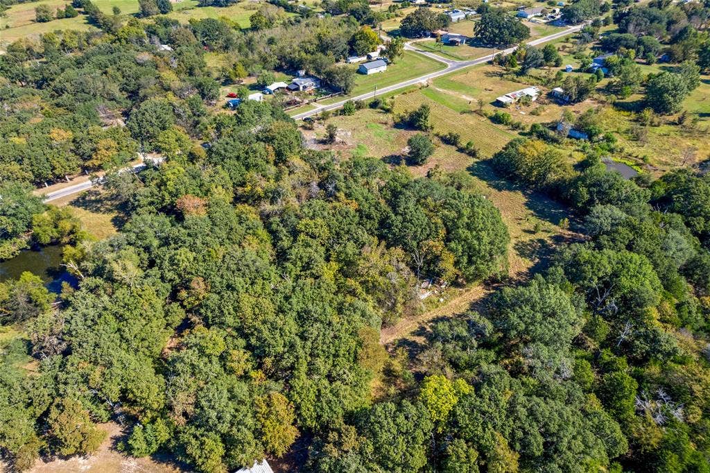 11691 Betty Lane, Kaufman, TX 75142 Expansive wooded acreage featuring mature trees and a tranquil water feature