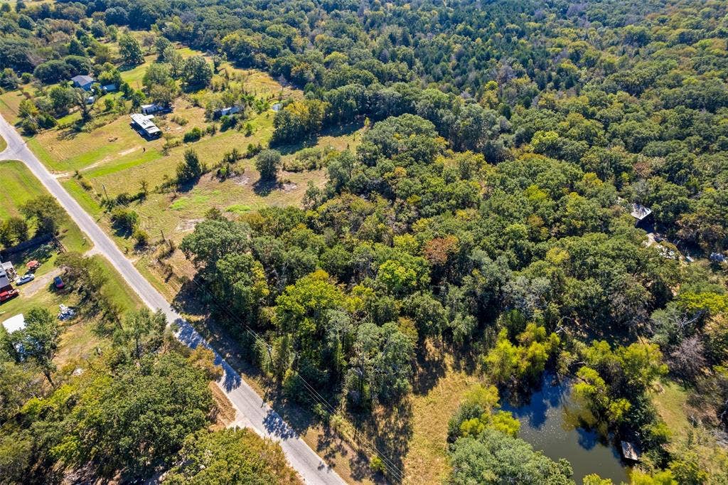 11691 Betty Lane, Kaufman, TX 75142 Expansive wooded acreage featuring a pond, established roadways, and scattered clearings