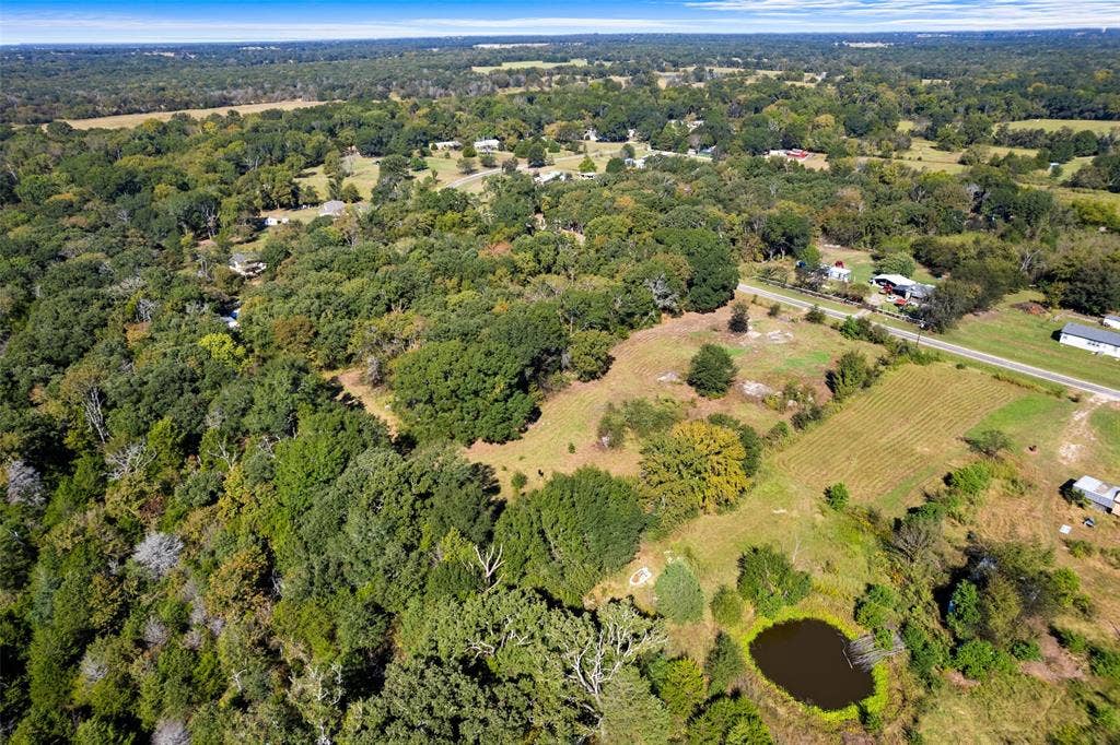 11691 Betty Lane, Kaufman, TX 75142 Expansive rural landscape featuring a private pond, open fields, and mature tree coverage