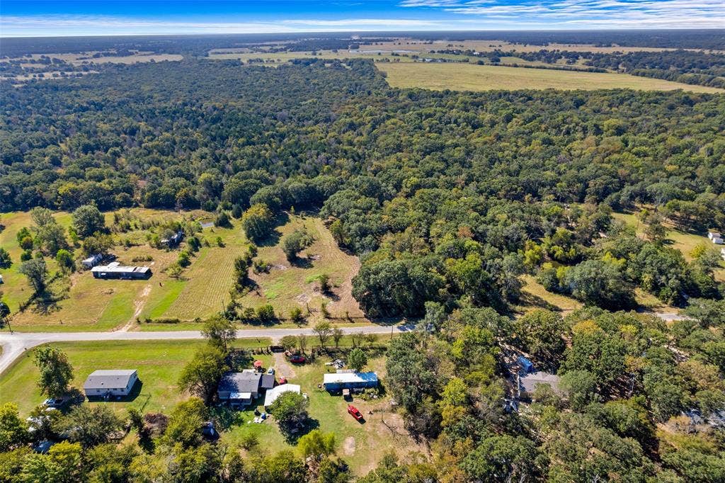11691 Betty Lane, Kaufman, TX 75142 Expansive rural landscape featuring a mix of mature woodland and open fields