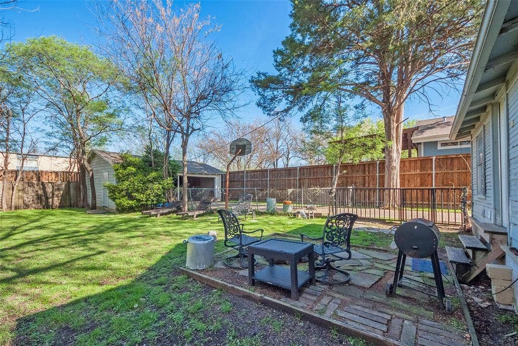 5405 Worth Street, Dallas, TX 75214 A cozy backyard with a patio area and a grill, perfect for outdoor cooking and relaxation.