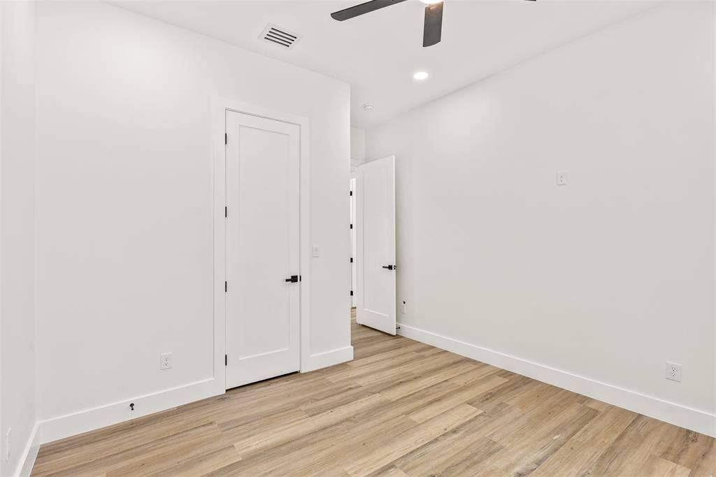 1407 Pueblo Street, Dallas, TX 75212 Room featuring wood-finish flooring, white baseboards, and white walls