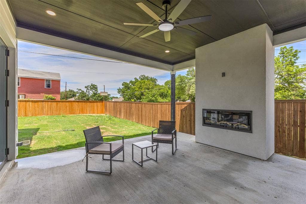 1407 Pueblo Street, Dallas, TX 75212 Covered patio featuring a built-in fireplace, ceiling fan, recessed lighting, and concrete flooring