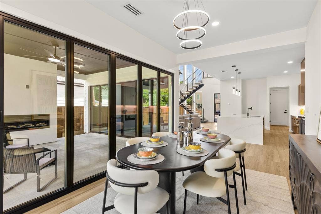 1407 Pueblo Street, Dallas, TX 75212 Dining area featuring wood-finish flooring and a contemporary chandelier