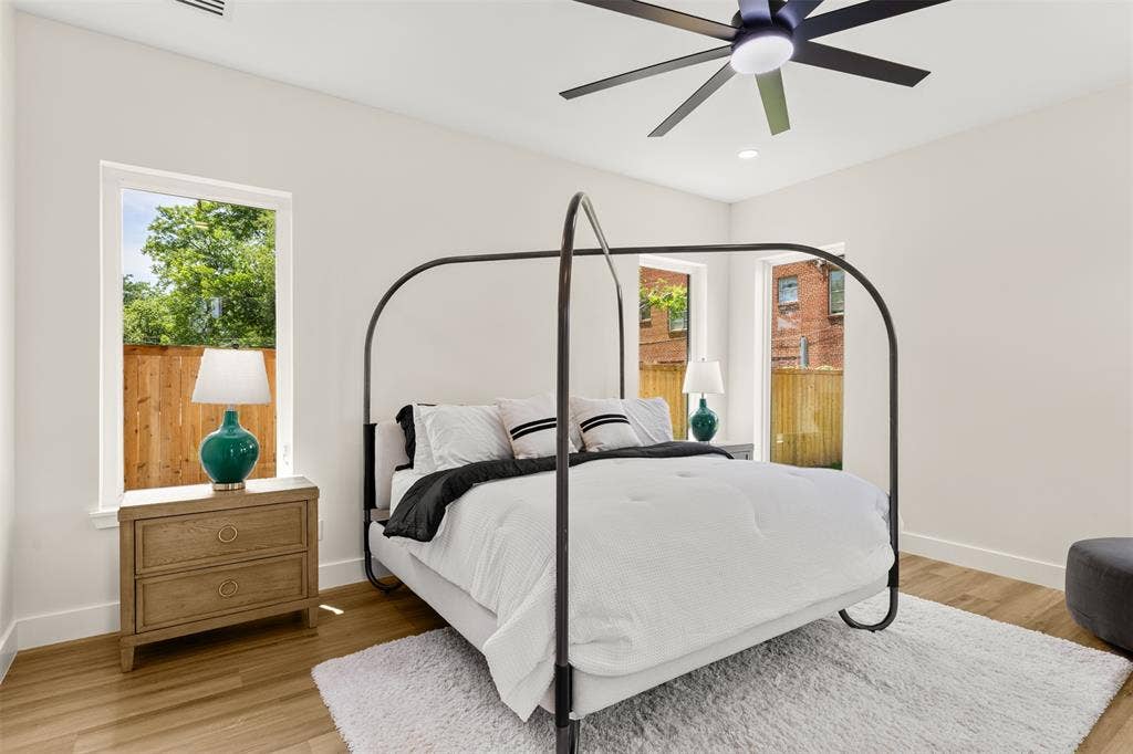 1407 Pueblo Street, Dallas, TX 75212 Spacious bedroom with wood-finish flooring, two large windows, recessed lighting, and a contemporary ceiling fan