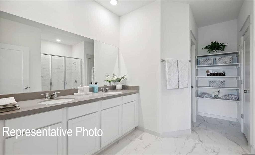 Dual vanity with undermount sinks and chrome faucets, set against a full-width mirror