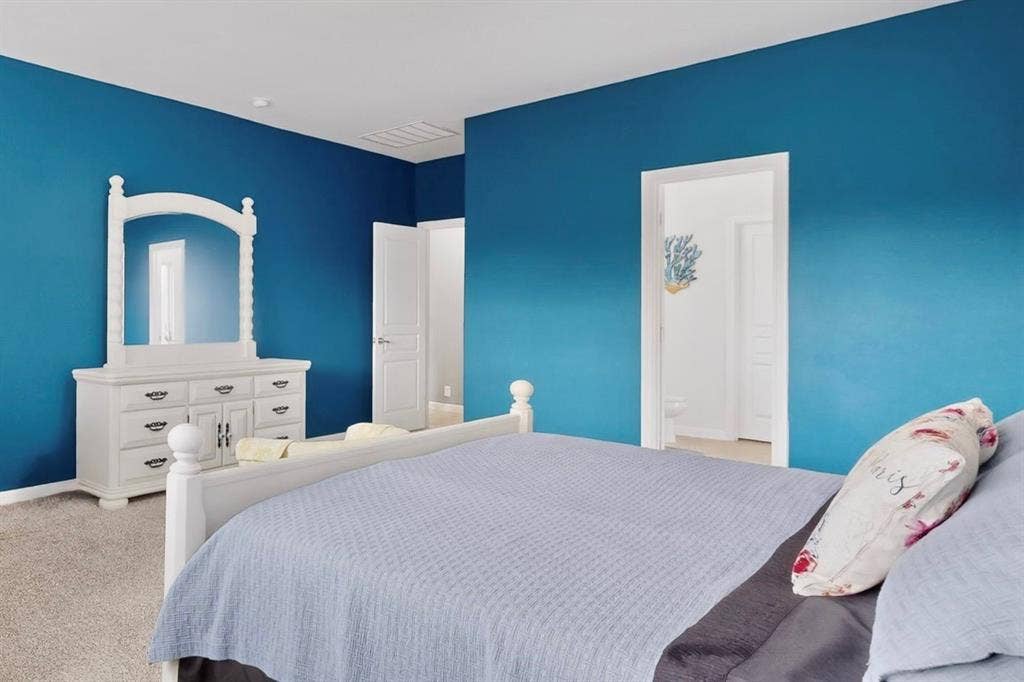 698 Langdon Street, Lavon, TX 75166 Carpeted bedroom with a bright blue accent wall and white trim