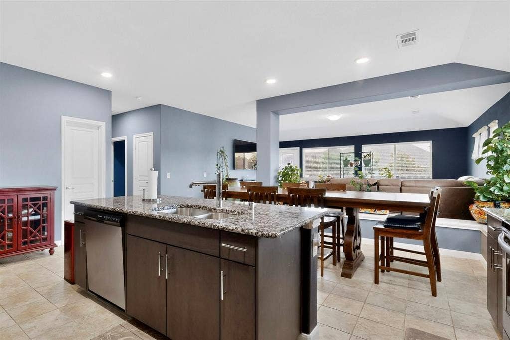 698 Langdon Street, Lavon, TX 75166 Kitchen island with granite countertop, stainless steel sink, and integrated dishwasher