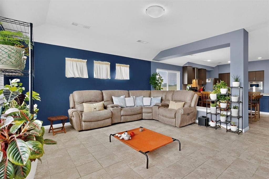 698 Langdon Street, Lavon, TX 75166 Spacious living area featuring tile flooring, a vaulted ceiling, and an open layout to the kitchen