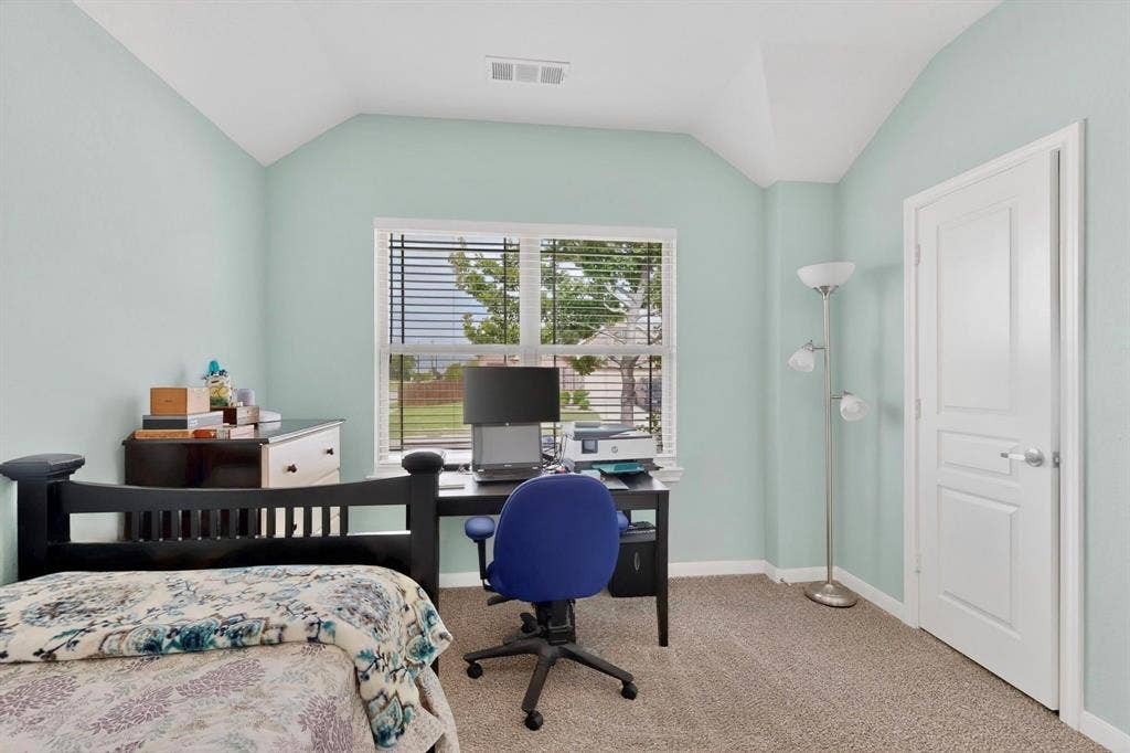 698 Langdon Street, Lavon, TX 75166 Carpeted room featuring a window with blinds, a vaulted ceiling, and a paneled interior door