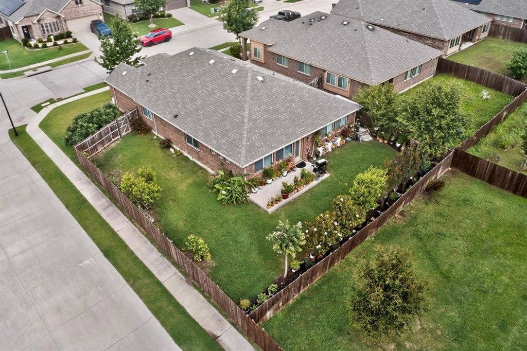 698 Langdon Street, Lavon, TX 75166 Expansive green lawn with established landscaping and a perimeter privacy fence