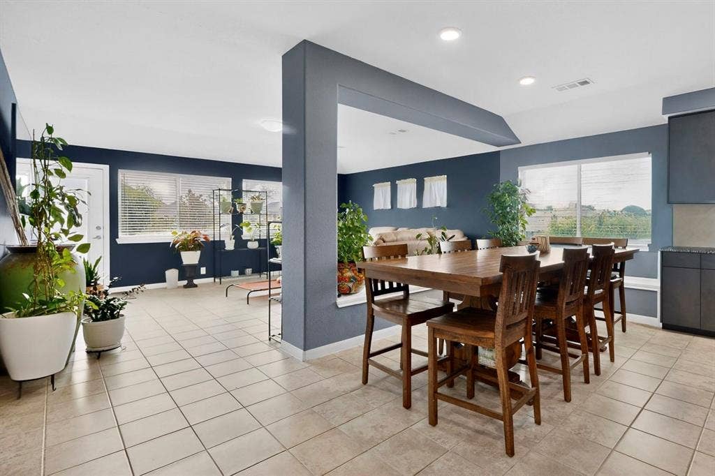 698 Langdon Street, Lavon, TX 75166 Open-concept living space featuring tile flooring, recessed lighting, and multiple windows with blinds