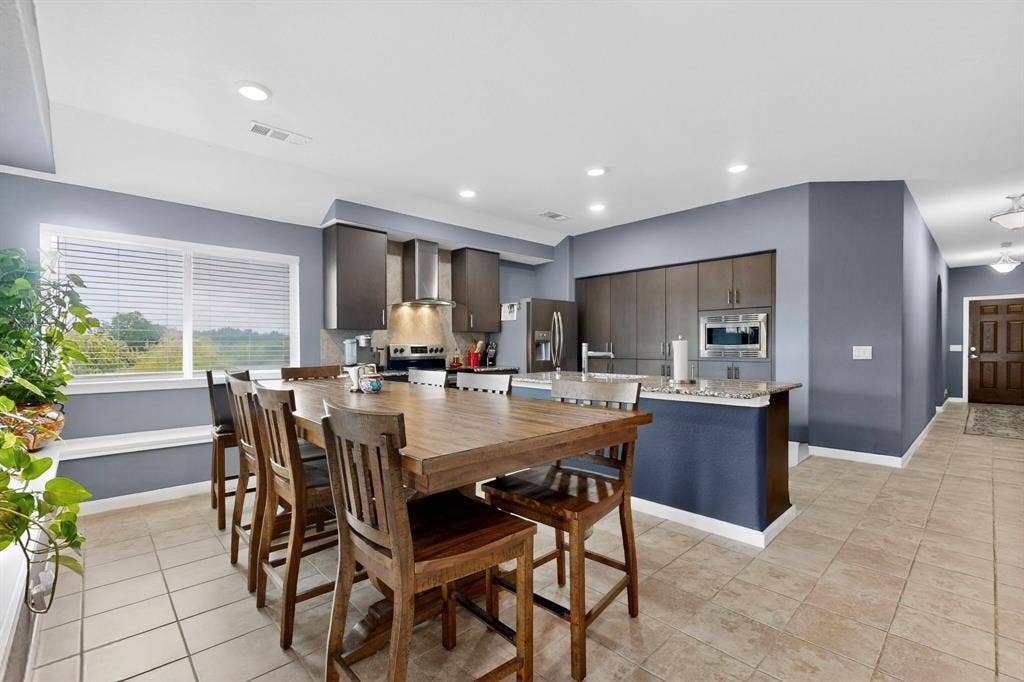 698 Langdon Street, Lavon, TX 75166 Open-concept kitchen and dining area featuring a built-in oven, stainless steel refrigerator, and recessed lighting