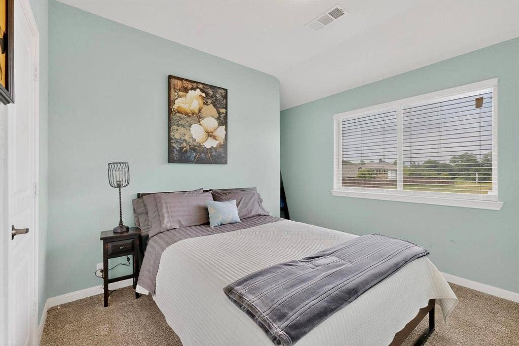 698 Langdon Street, Lavon, TX 75166 Carpeted room featuring light blue walls, white trim, and a large window with white blinds