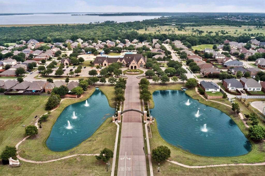 698 Langdon Street, Lavon, TX 75166 Aerial perspective showcasing a residential community with two prominent water features