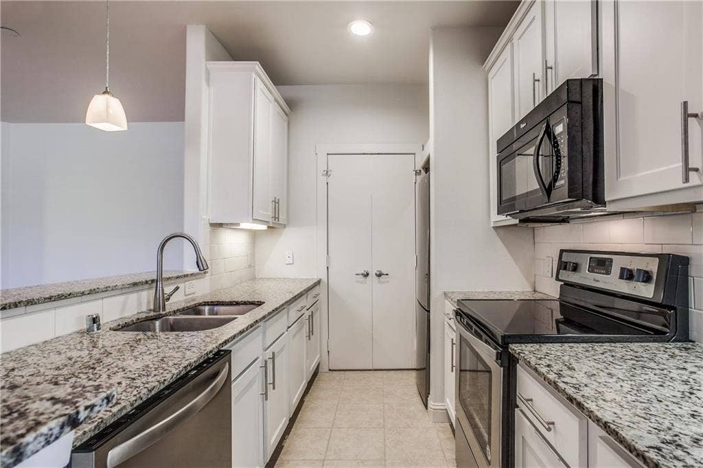 6159 Oram Street, #302, Dallas, TX 75214 Granite countertops, stainless steel appliances, updated cabinetry and sleek backsplash add style to this home