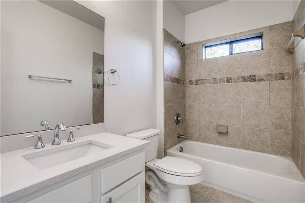 6159 Oram Street, #302, Dallas, TX 75214 Second bath with updated cabinetry and tile surround tub/shower combo.
