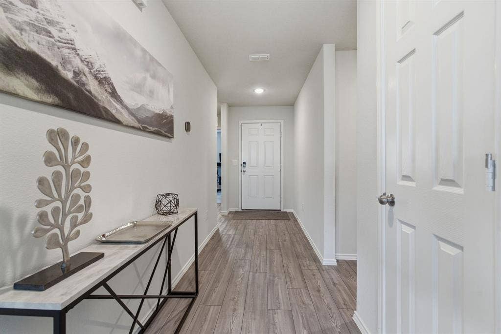 Entryway featuring wood-look tile flooring, recessed lighting, and a paneled interior door