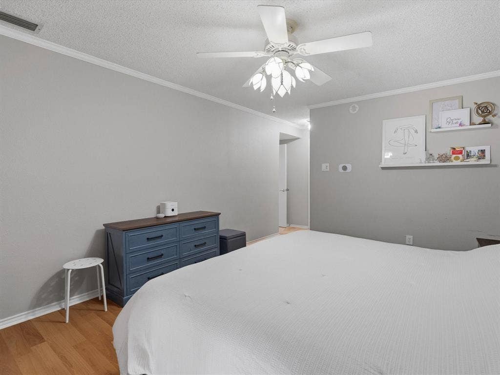 2812 Prescott Drive, Carrollton, TX 75006 Light wood-finish flooring with crisp white baseboards and crown molding