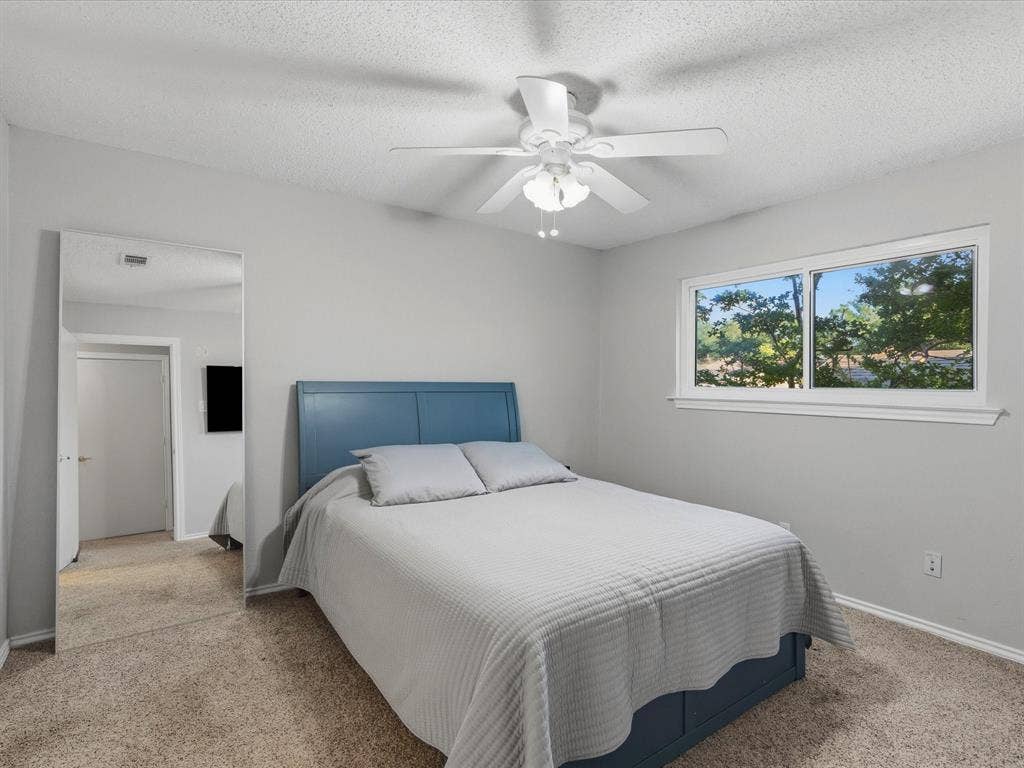 2812 Prescott Drive, Carrollton, TX 75006 Room featuring light-colored walls, carpet flooring, a ceiling fan with integrated lighting, and a window with white trim