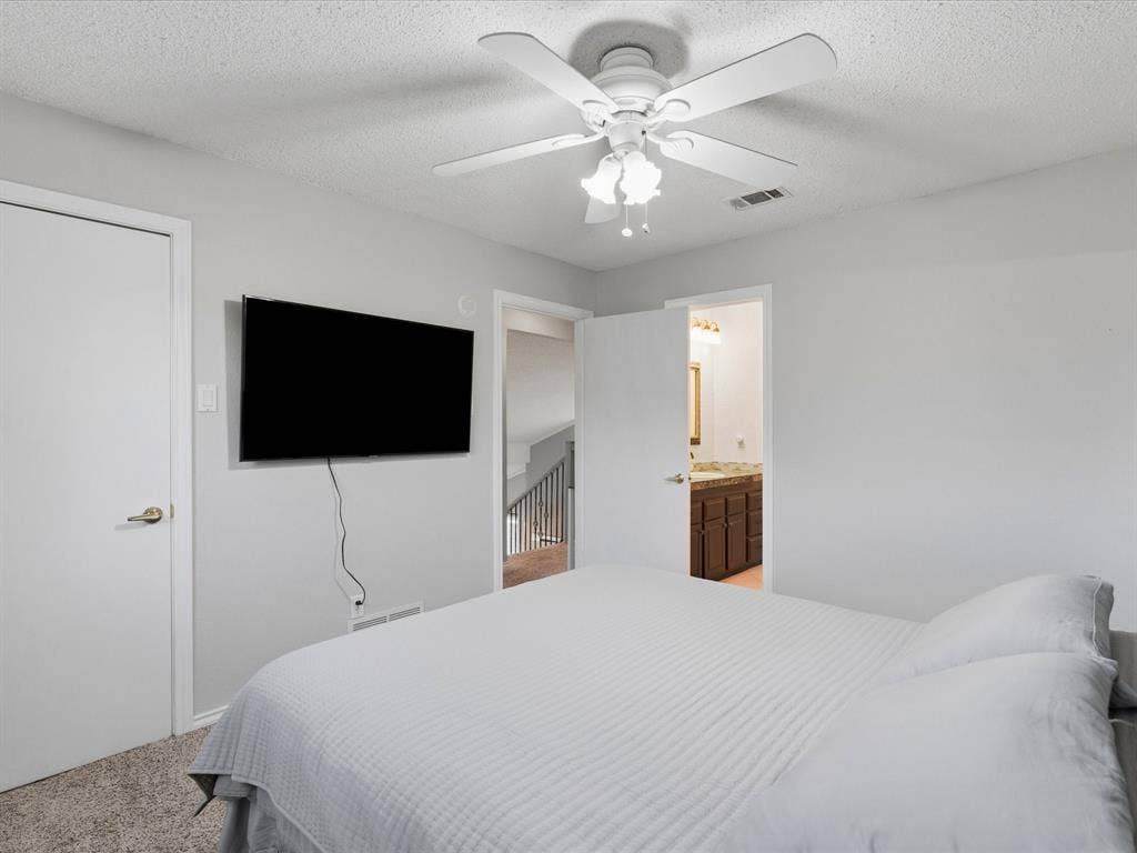 2812 Prescott Drive, Carrollton, TX 75006 Carpeted room featuring a ceiling fan with light fixture and light gray walls