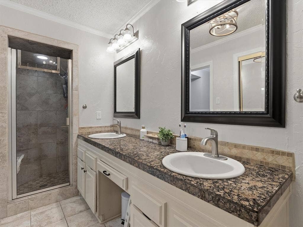 2812 Prescott Drive, Carrollton, TX 75006 Dual vanity with granite-style countertops, under-mount sinks, and a mosaic tile backsplash
