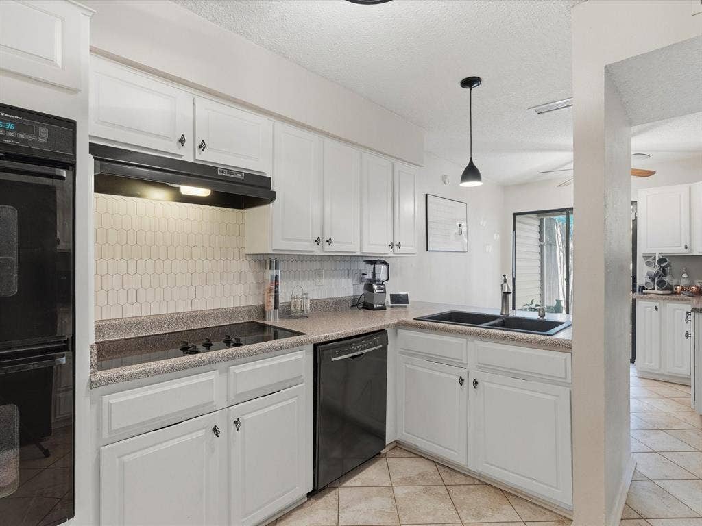 2812 Prescott Drive, Carrollton, TX 75006 Kitchen featuring white cabinetry, a black built-in oven, black cooktop, black dishwasher, and a black double-basin sink