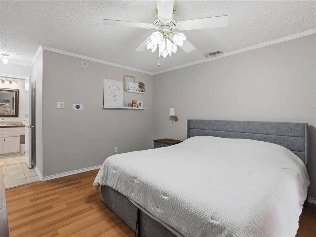 2812 Prescott Drive, Carrollton, TX 75006 Wood-finish flooring throughout, complemented by a ceiling fan with light fixture