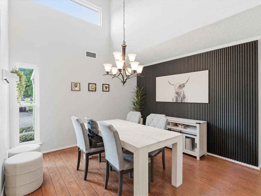 2812 Prescott Drive, Carrollton, TX 75006 Dining space featuring a vaulted ceiling and a high transom window